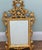 Elegant Italian Rococo style wall mirror with a richly carved giltwood frame Decorated with pierced scrolling acanthus...