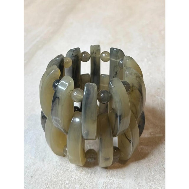 This vintage boho stretch bracelet is built from an irregular assortment of chunky lucite panels and rounded beads, each...
