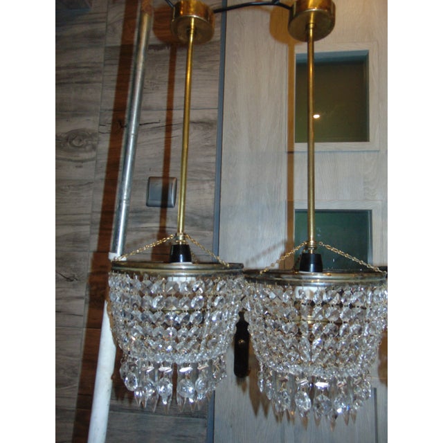 A brass chandelier with glass crystals from the 1970s. European Plug (up to 250V).The wiring of this item may be original...