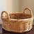 A beautifully crafted vintage wicker basket featuring traditional French randing, substantial braided rim, and sculptural...
