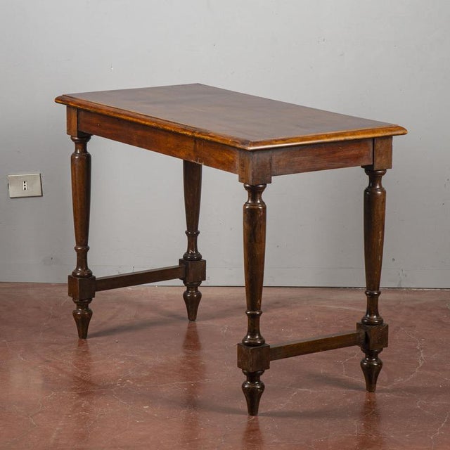 An elegant, small-sized vintage table, ideal as a desk, entryway console, or serving table. The wooden frame, presumably...