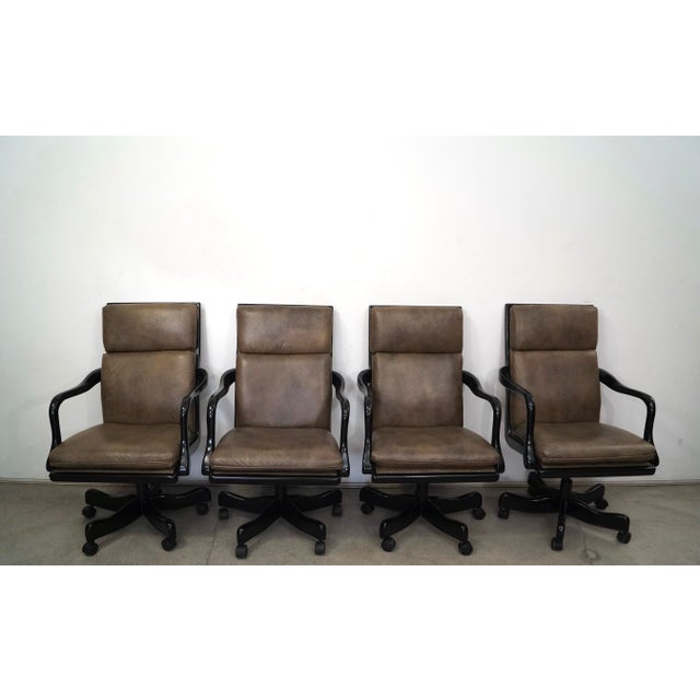 Set of four Hollywood Regency executive conference chairs for sale. These were manufactured by high-end office furniture...