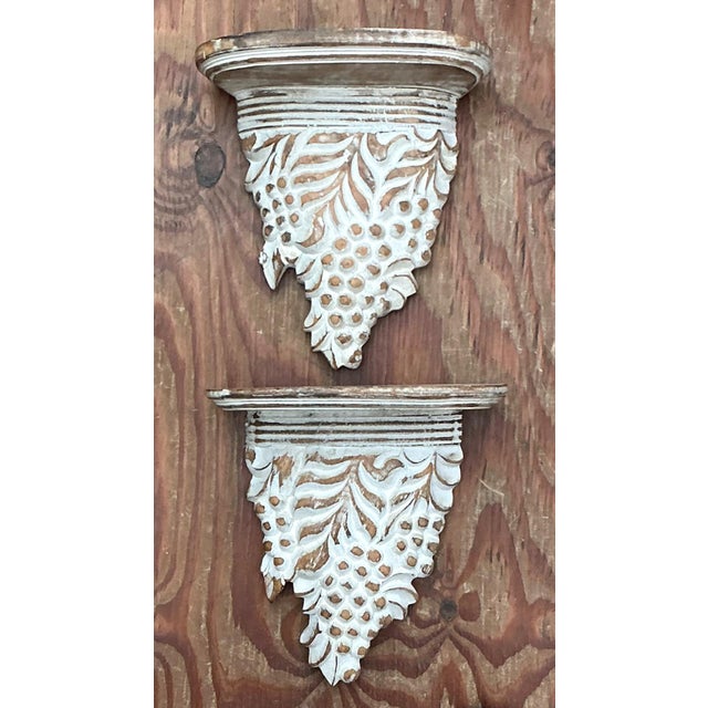 This charming pair of vintage carved wood wall brackets features a classic grape and foliage motif, celebrating...
