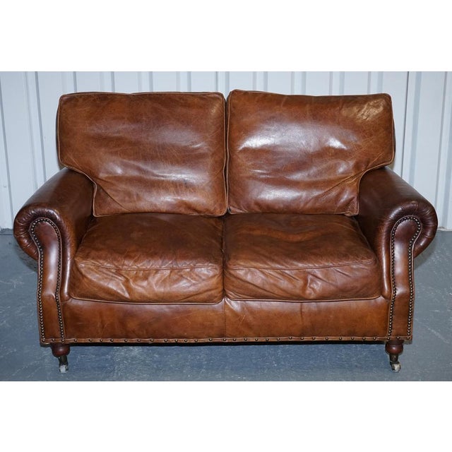 This striking Balmoral two-seater sofa by Halo, in the manner of Timothy Oulton, embodies the bold, heritage-inspired...