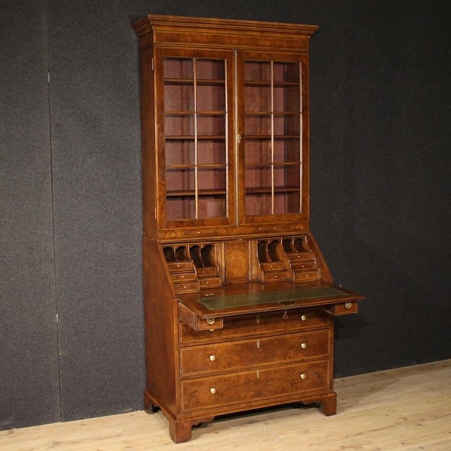 English double-body cabinet from the mid-20th century. Georgian-style furniture carved and veneered in walnut, mahogany,...
