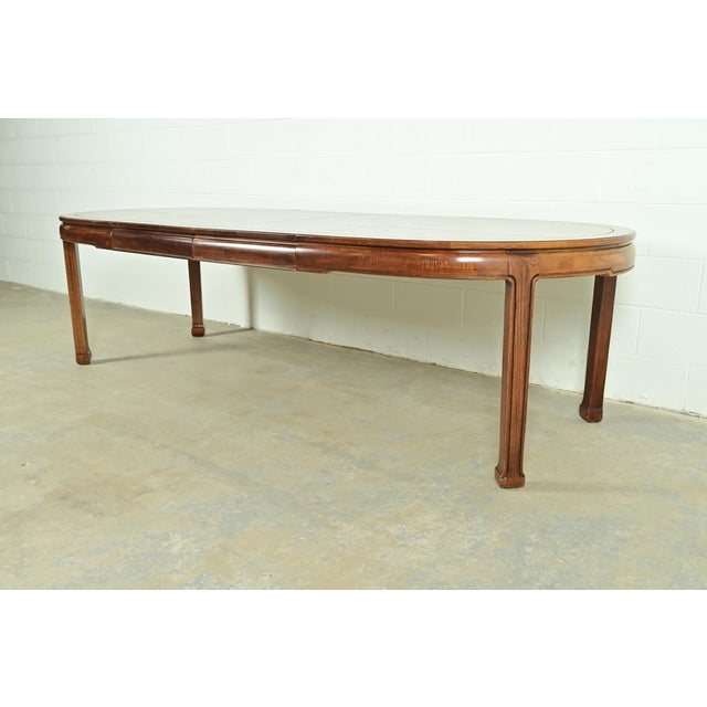 An exceptional mid-century modern Hollywood Regency Chinoiserie sculpted walnut extension dining table By Thomasville USA,...