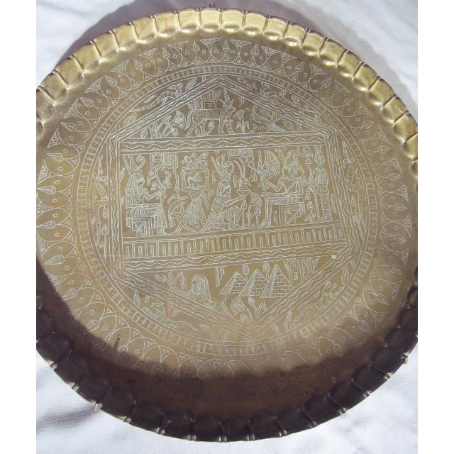 Oversized Vintage Moroccan Brass tray with embossed design. Pie Crust edge with handing hardware on the back. It weighs...