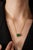 This solitaire pendant necklace features a 7.7-carat octagon emerald set in 14K yellow gold. The emerald measures 12.43 x...