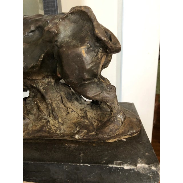 Bronze Cow sculpture with beautiful patina poised on a slate base.