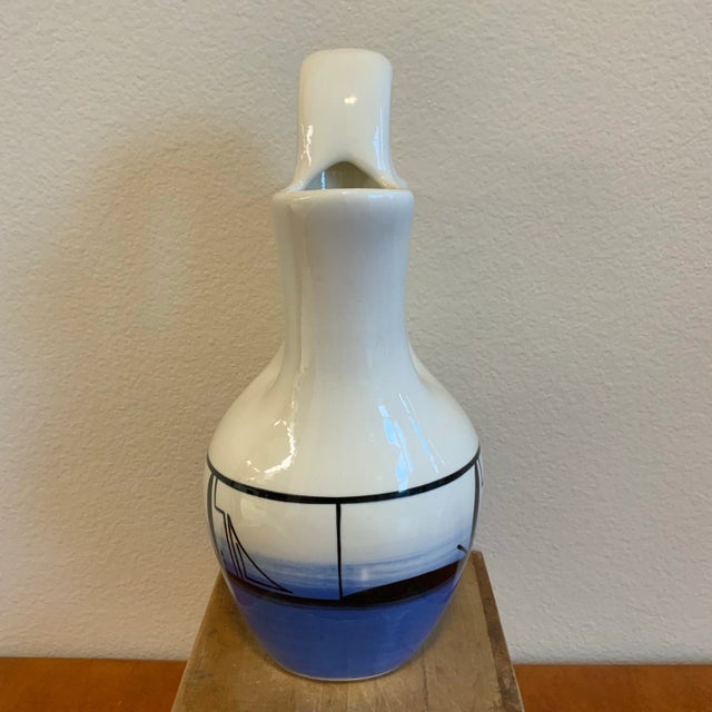 A beautifully signed Native American wedding vase by Wanda Jacket (Ute Mountain Ute Tribe). The double-spout form...