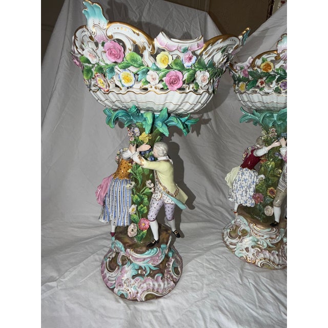 An exceptional and monumental pair of Meissen porcelain figural compotes in the Rococo Revival style, dating to the late...