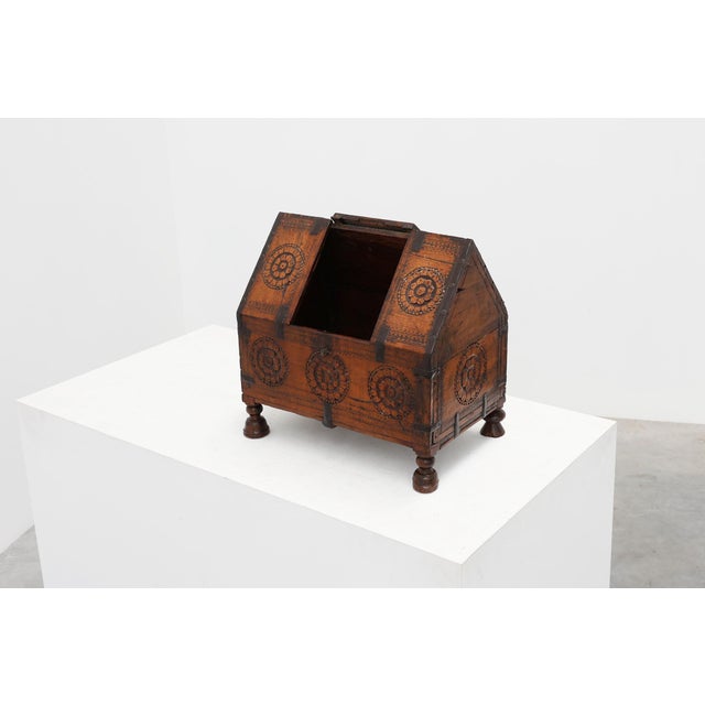 A charming 18th century carved wooden coffer distinguished by its unusual slanted hinged lid and richly decorated...