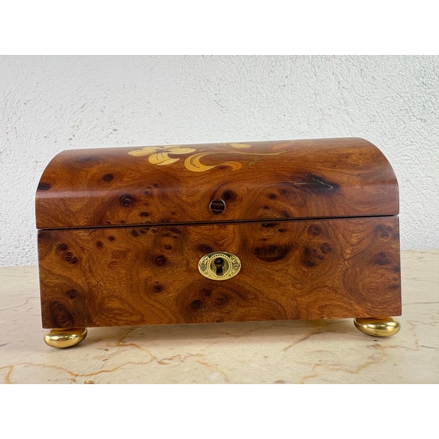 This is a handsome handcrafted burled walnut music box. This dome shaped box is handcrafted with burled walnut satin wood...