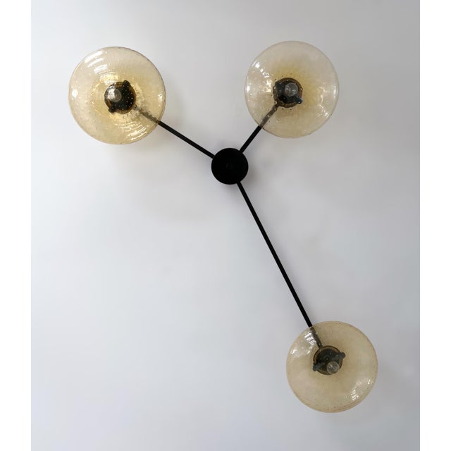 Italian flush mount with three amber Murano glass shades carefully hand blown with bubbles inside the glass using...