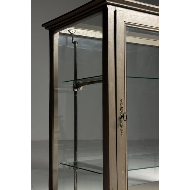 Grey French display cabinet. Early 20th-century French display cabinet. Made of pine, painted grey. with 2 glass shelves....