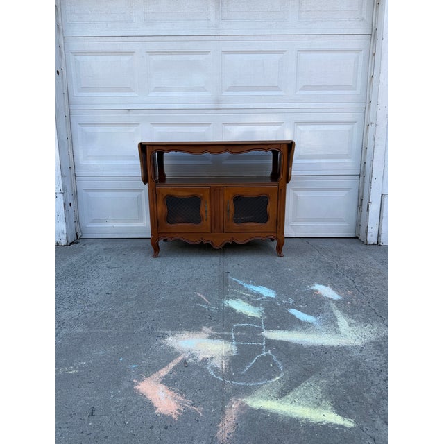 We have a beautiful vintage French Provincial buffet server for sale. It features an expandable drop leaf top, decorative...