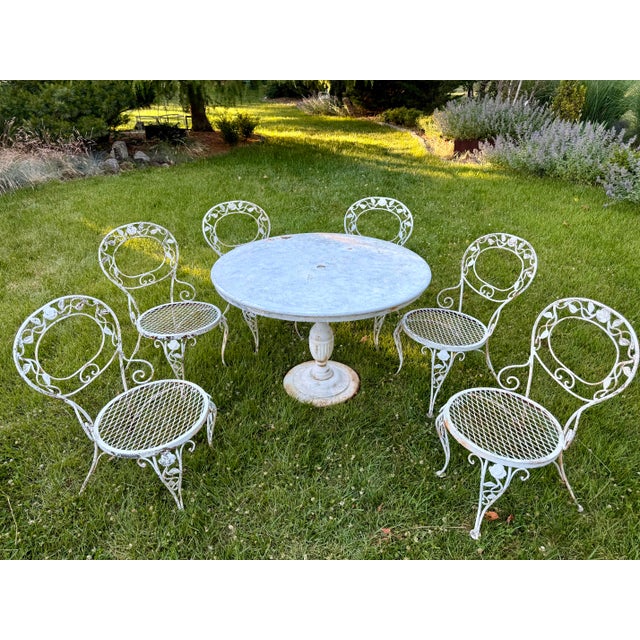 A complete seven-piece vintage dining set in Woodard’s coveted “Chantilly Rose” pattern, produced by Woodard of Owosso,...
