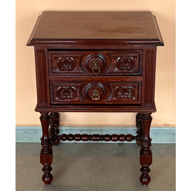 A French chestnut two-drawer commode from the late-19th century with ribbon-carved moldings and carved skirt. This petite...