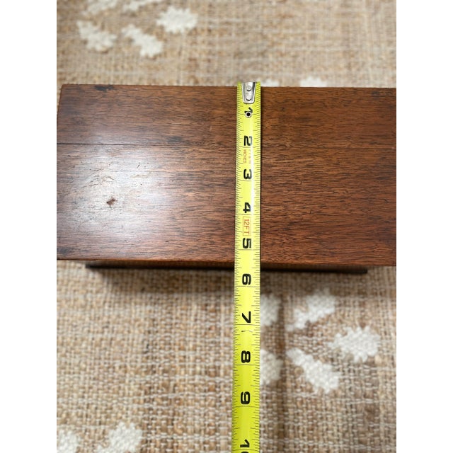 The Antique Brown Wooden Dresser Desk Top Sewing Box is a vintage and charming piece that serves as a functional sewing...