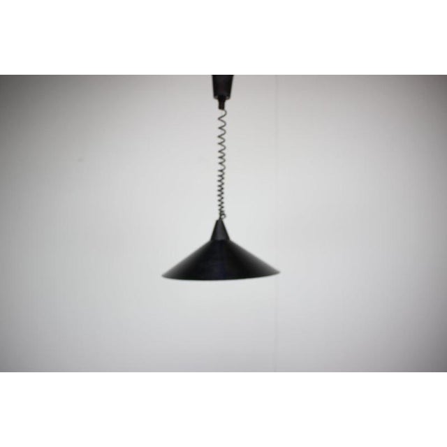 Original 1970s Czechoslovakian pendant lamp with a distinctive Space Age silhouette and an unusual coiled suspension...