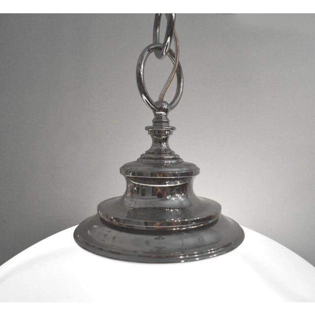 Nickel plated solid brass fittings surround a white glass shade imported from Italy. Inside are 3 candelabra sockets that...