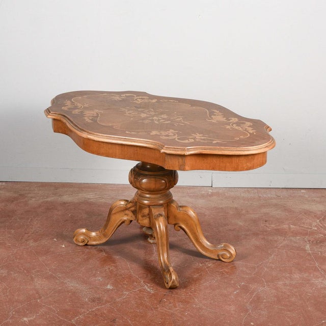 This coffee table, with its distinctive biscuit shape and fine inlays, is a piece of furniture that evokes classic italian...