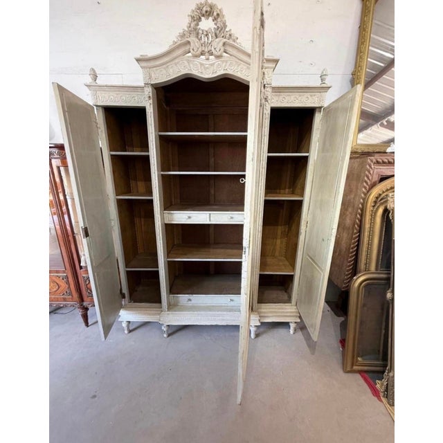 large French louis XVI 3 door bookcase or Armoire made of solid walnut. The wood has the original French paint from the...