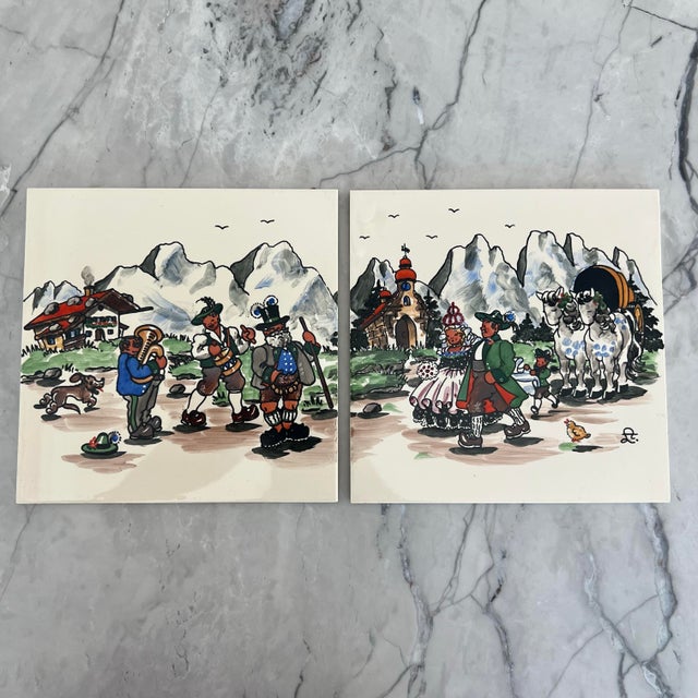 Set of 4 vintage tiles handpainted in Munich, Germany. Features two different scenes. Each tile measures approximate 6”...