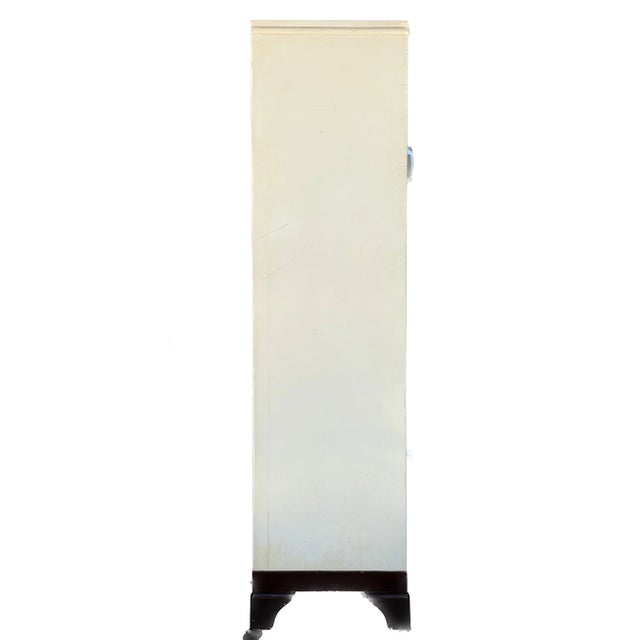 A striking mid-century medical cabinet that perfectly bridges industrial function and vintage elegance. Attributed to...