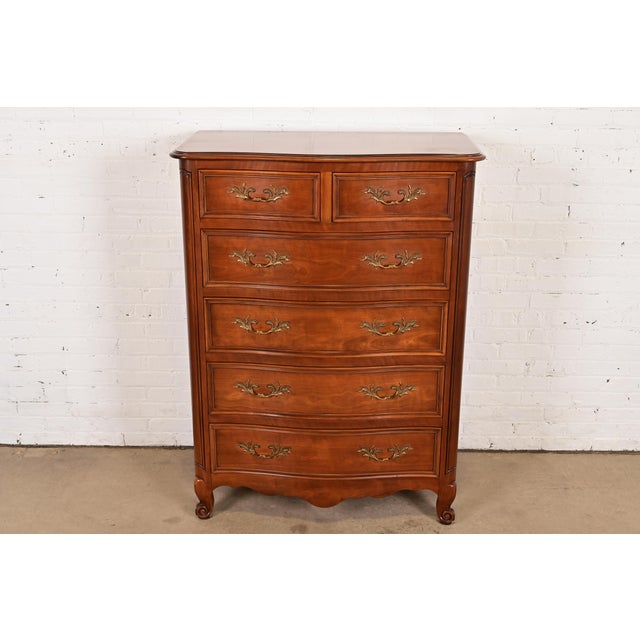 An exceptional French Provincial Louis XV style six-drawer highboy dresser or chest of drawers By Kindel Furniture USA,...