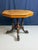 This Victorian-era octagonal centre table with removable top, created around 1900, features a burr walnut finish. The...
