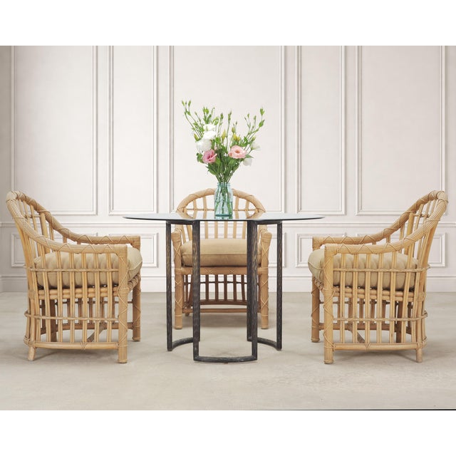 A stylish weathered set of eight mid-20th century patio and garden dining armchairs designed by Danny Ho Fong for Fong...