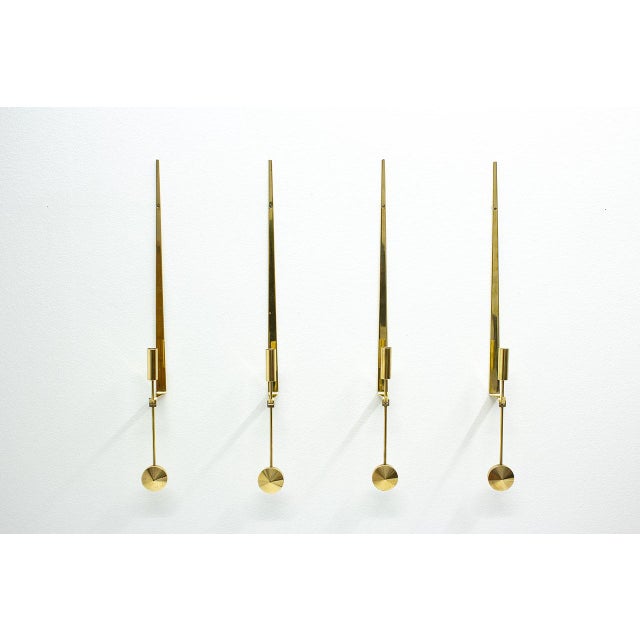 Set of four wall mounted “Pendulum” candlesticks designed by Pierre Forssell. Manufactured in Sweden by Skultuna during...