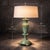 A richly patinated late 20th century urn-form table lamp featuring layered verdigris tones and classical fluted detailing....