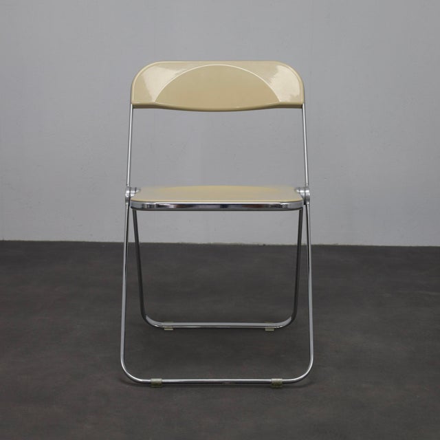 A pair of iconic plia folding chairs designed by giancarlo piretti for castelli in the 1970s. Celebrated for their...