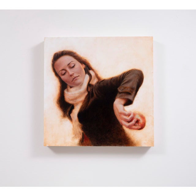 In "A Mirror to Presence," a woman, draped in a soft scarf, gazes inwardly while poised with an apple in her hand,...