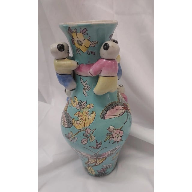 Rare Chinese Fertility Vase. Light blue background with multiple porcelain figures attached. Statement piece on its own or...