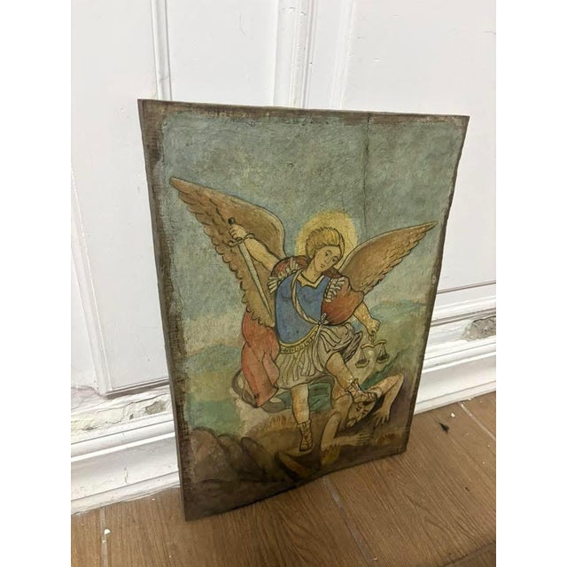 Sculpture on an antique wooden panel. Saint Michael the Archangel is the Prince of the Heavenly Host, revered as God's...