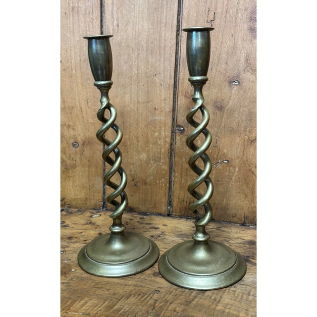 This pair of antique English brass open barley twist candlestick holders feels like a fragment of a candlelit past,...
