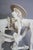 Expressive and highly stylized porcelain sculpture depicting Don Quixote beside his weary horse, rendered in an elongated...