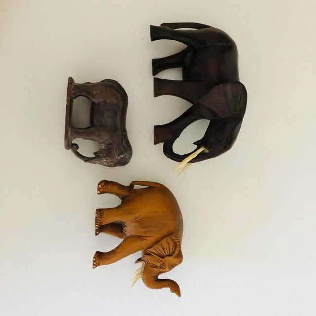 Vintage set of 3 elephant figurines , 2 wooden and 1 soap stone , no makers mark, they are in excellent condition.