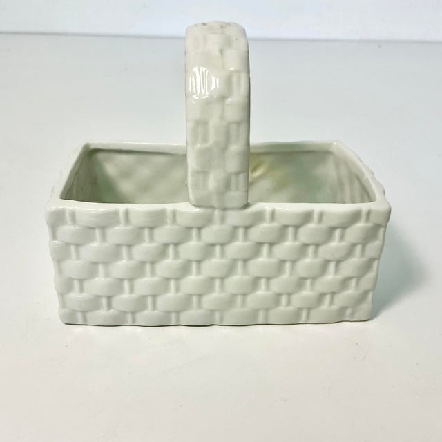 This little white ceramic rectangular faux wicker basket is a candy dish. Add colorful jelly beans and display in any room...