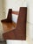 Beautiful vintage Danish modern wall-mounted shelf featuring sculptural wooden side supports, a warm wood finish, and...