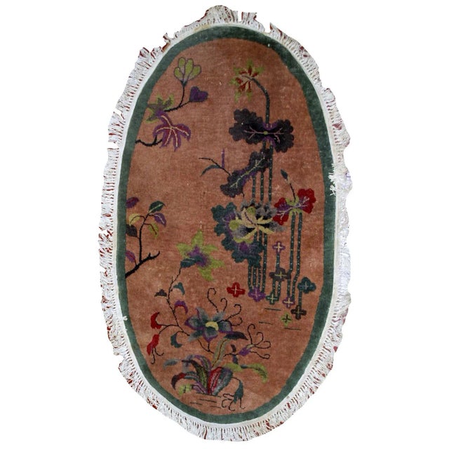 Handmade antique Art Deco Chinese rug in original condition. The rug is in oval shape. the peach background decorated in...