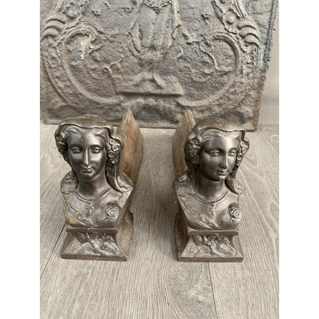 This 19th-century cast iron fireplace set is a true testament to the splendor of bygone craftsmanship. The back panel,...