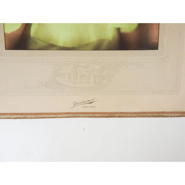 Vintage circa 1920's hand tinted glamour photograph portrait of young woman in green and pink dress. Steinheimer Paris...