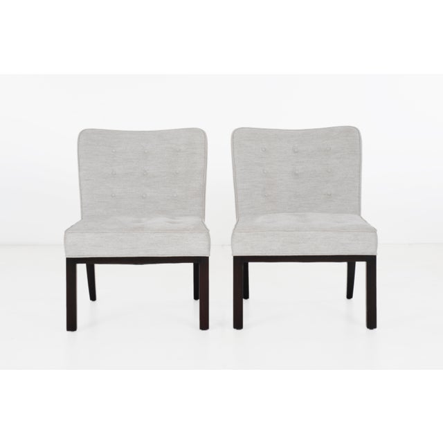 Early Edward Wormley for Dunbar slipper chairs. Lacquered mahogany legs with newly reupholstered button tufted seat and...