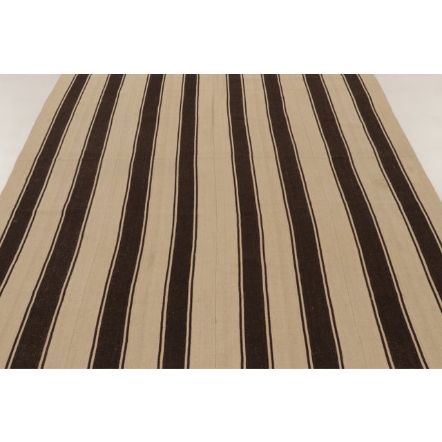 Handwoven in wool, this 6x8 vintage Persian kilim is a sophisticated addition to Rug & Kilim’s Kilim & Flatweave...