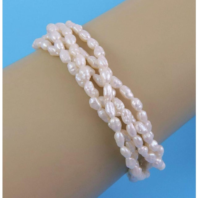 This beautiful authentic bracelet is from Mikimoto, the screw in double ball clasp is crafted from 18k yellow gold with a...