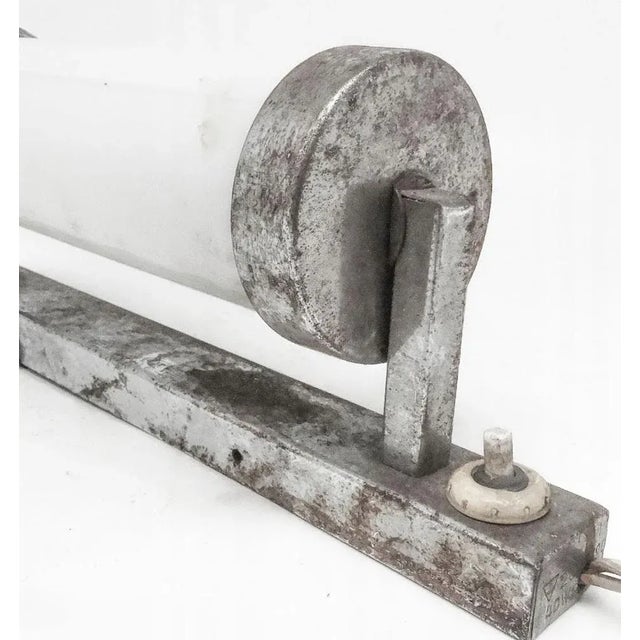 The wall lamp comes from the 1950s. I have official proof of authenticity such as vintage catalogs, designer records, or...